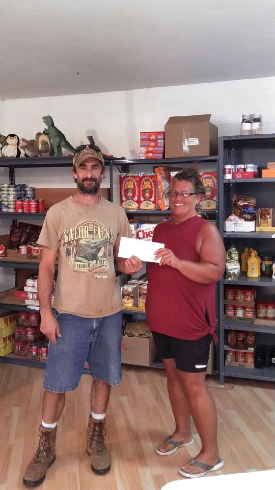 Lion President Tim Leising and Food Pantry rep Dina Potter